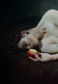 Midsection of woman eating apple