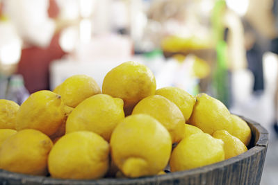 Close-up of yellow fruits in basket at market stall