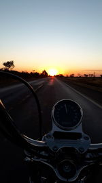 Car on road against sky during sunset