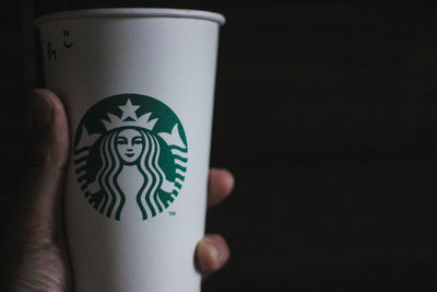 Close-up of hand holding coffee cup