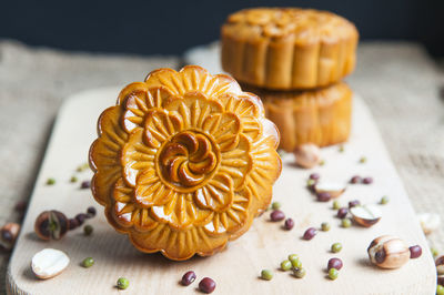 High angle view of moon cakes with seeds on board