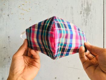 Midsection of people holding multi colored wall