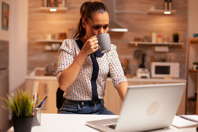 Young woman using mobile phone in cafe