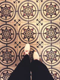 Low section of woman standing on tiled floor