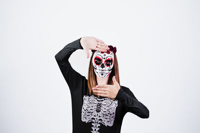 Woman holding umbrella against white background