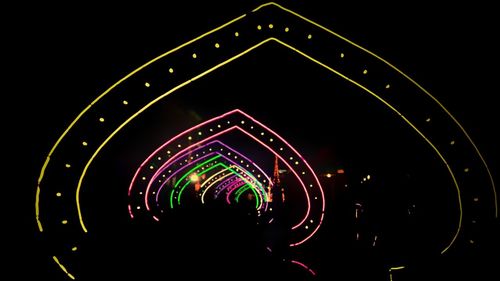 Illuminated light trails against sky at night