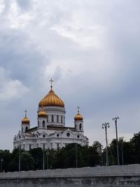 Low angle view of church against cloudy sky