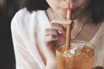 Close-up of woman drinking glass