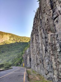 Road by mountain against clear sky