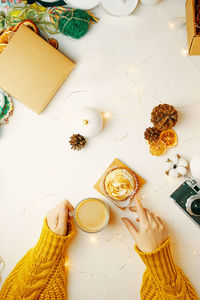 High angle view of woman holding food on table