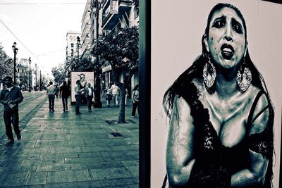 Portrait of woman standing on street in city