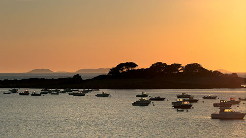 Scenic view of sea against clear sky during sunset