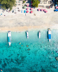 Boats in swimming pool against sea