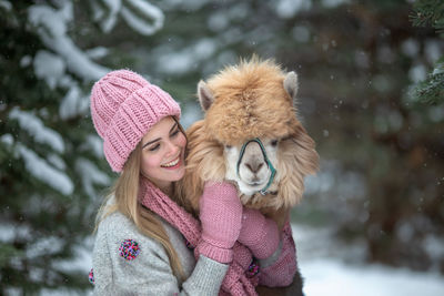 Portrait of smiling young woman with dog
