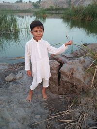 Portrait of boy standing in lake