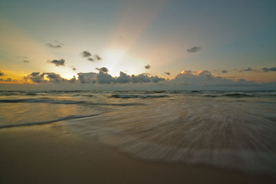 Scenic view of beach against sky during sunset