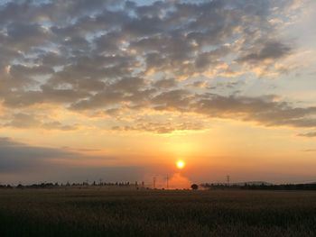 Scenic view of field against sky during sunset