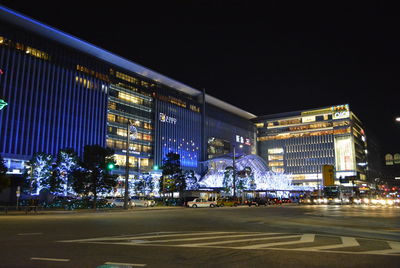 Illuminated city street and buildings at night