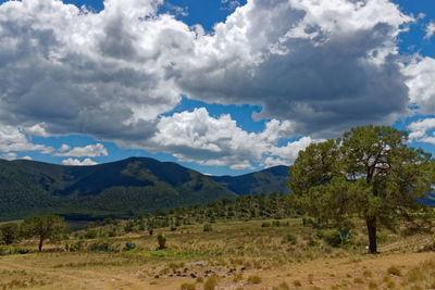 Scenic view of mountains against cloudy sky