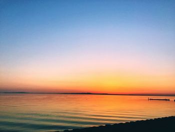 Scenic view of sea against clear sky during sunset