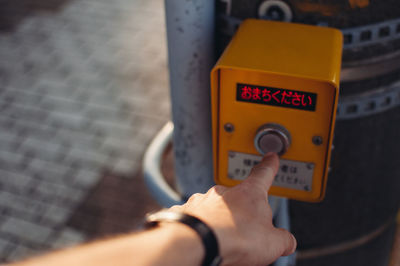 Close-up of human hand pressing button