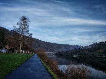 Scenic view of river against cloudy sky