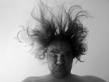 Portrait of young man against white background