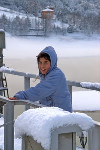 Portrait of boy with snow in winter