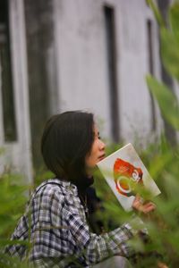 Portrait of woman with pink flower