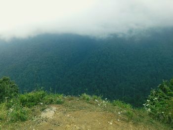 Scenic view of mountains against cloudy sky