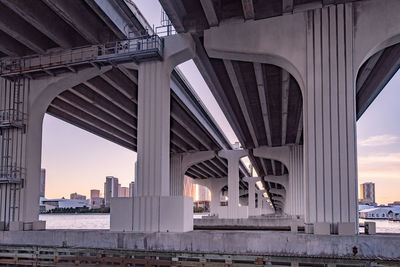 View from a boat underneath the macarthur causeway bridge in miami, florida taken at dusk.