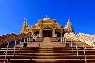 Low angle view of temple building against blue sky