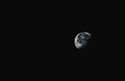 Low angle view of moon against sky at night