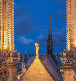 Notre dame de paris against cloudy sky at dusk