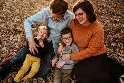 Cute young family smiling and laughing on a fall evening