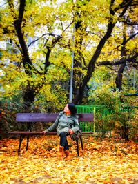 Man sitting on bench in park