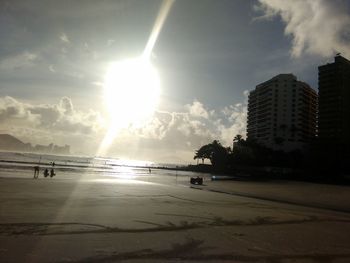 Scenic view of sea against cloudy sky at sunset