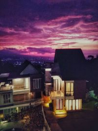 High angle view of illuminated buildings against sky at sunset