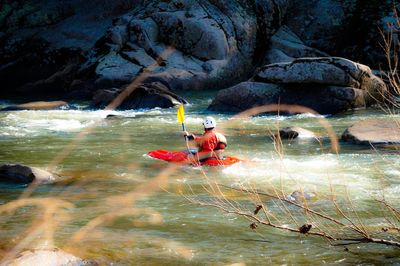 Man kayaking in river