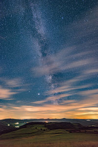 Scenic view of landscape against sky at night