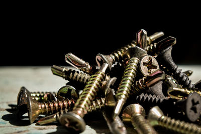 Close-up of chain on table against black background
