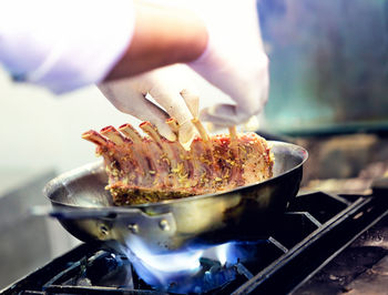 Cropped hand of person preparing food