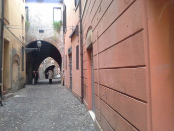 Man walking in corridor of building