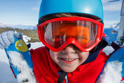 Portrait of woman wearing sunglasses standing on snow