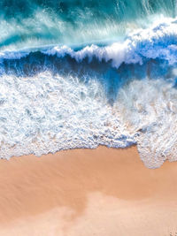 High angle view of waves rushing towards shore