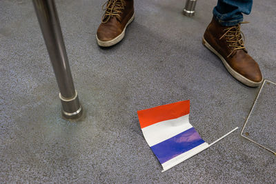 Low section of person by flag on ground