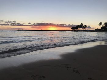 Scenic view of beach against sky during sunset