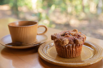 Coffee cup and cake on table