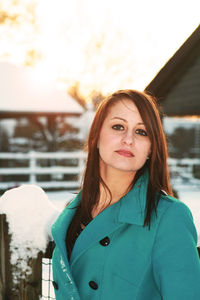 Portrait of beautiful woman standing in snow