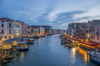 Panoramic view of illuminated buildings in city against sky